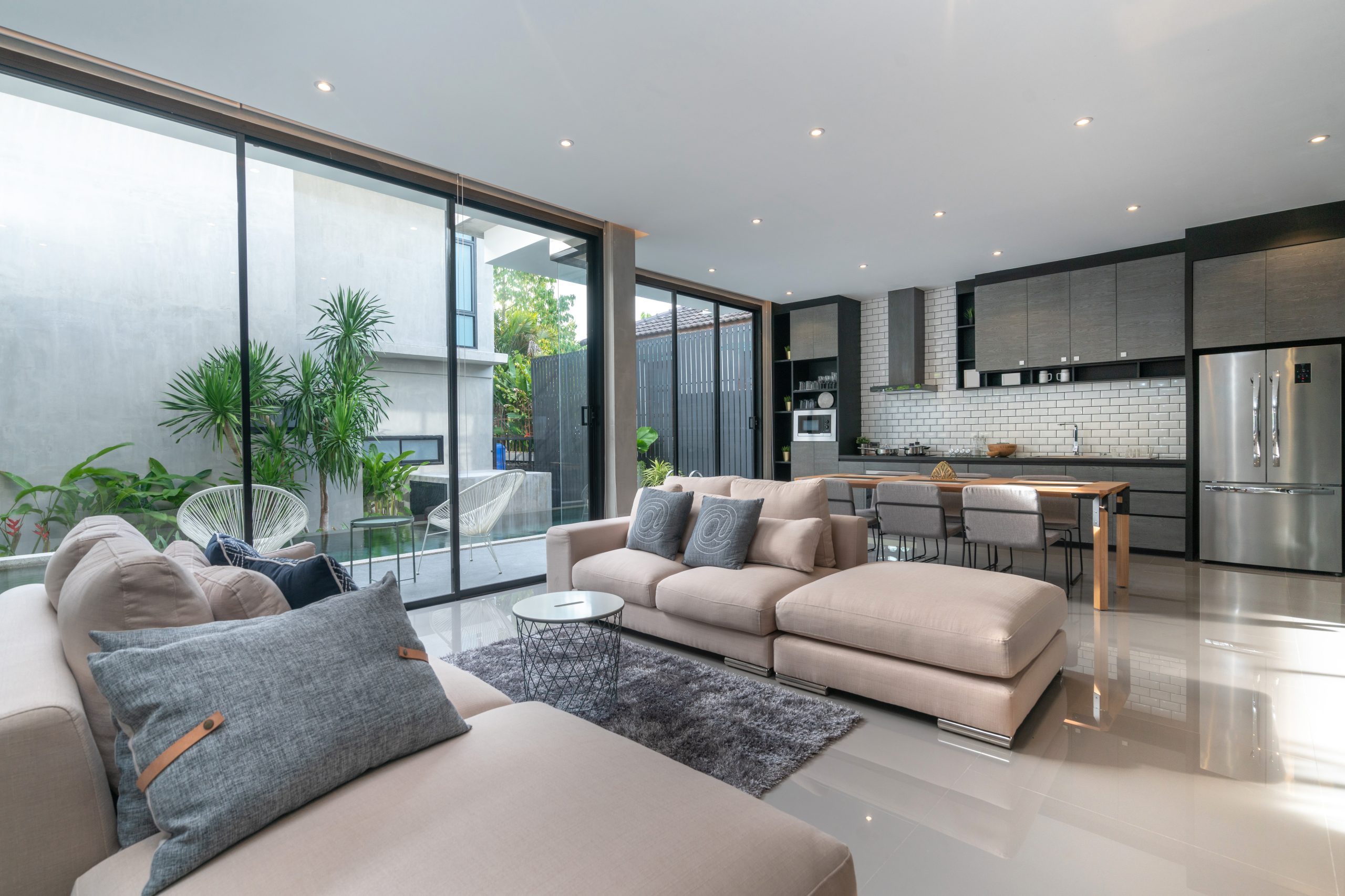 A modern living room with sliding glass doors that requires move out cleaning. A modern living room with sliding glass doors that requires move out cleaning.